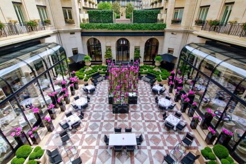 an overhead view of a courtyard with tables and chairs at Four Seasons Hotel George V Paris in Paris