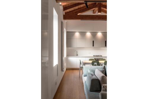 a kitchen and a living room with a couch and a table at Via del Pontile in Nesso