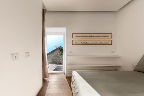 a bedroom with a bed and an open door at Via del Pontile in Nesso