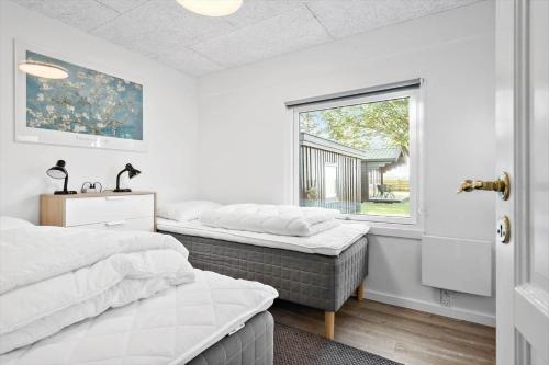 a bedroom with two beds and a window at S742-Stroby-Garderhojen-32 in Strøby
