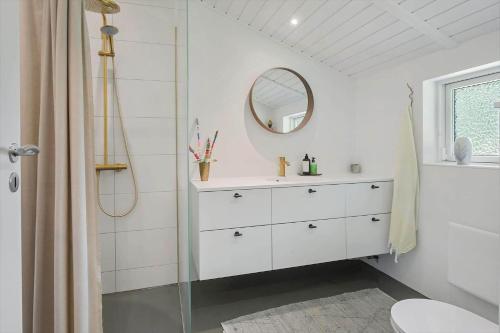 a white bathroom with a sink and a mirror at 3077-Stege-Bundgarnet-137-B in Stege