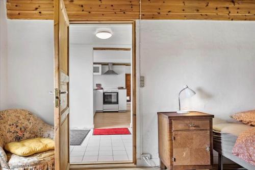 a room with a door open to a kitchen with a couch at 4320-Stege-Oddermose-Strandvej-5-B in Stege