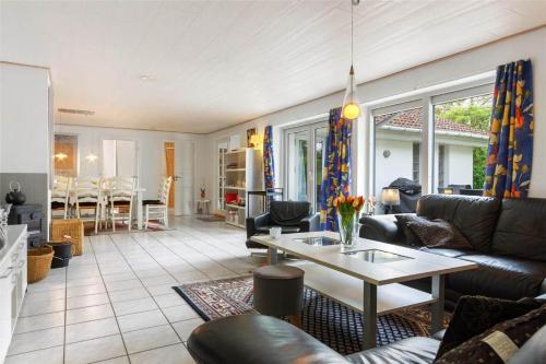 a living room with a couch and a table at 1305-Stege-Kaerhogevej-29 in Stege