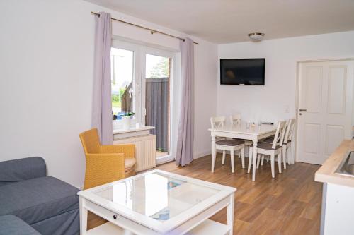 a living room with a couch and a table at Appartementhaus Schleiblick in Kappeln