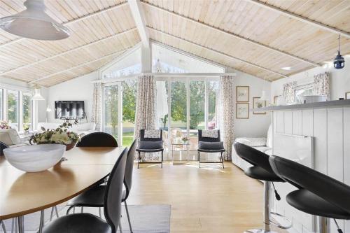 a kitchen and dining room with a table and chairs at 3304-Stege-Kvaerken-42 in Stege