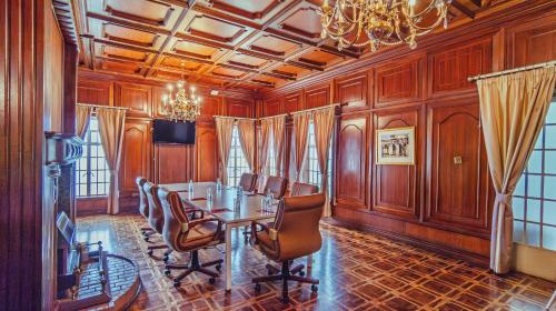 a dining room with a table and chairs at Muthu Sovereign Suites & Spa, Limuru Road, Nairobi in Limuru