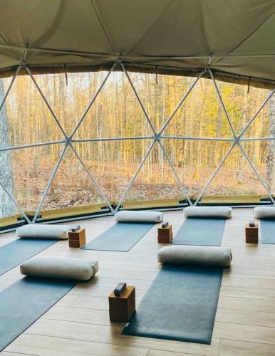 a group of yoga mats in a room with a large window at Lakeside Calm at Dimensions - Cabin One in Algonquin Highlands