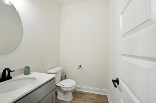 a white bathroom with a toilet and a sink at Arte Luxury Townhomes B1 I Comfy 2 Bed 25 Bath in Oak Grove
