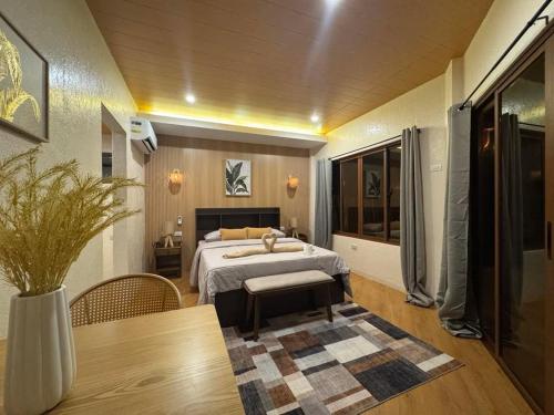 a bedroom with a bed and a table in a room at Siquijor Glamping Village in San Juan
