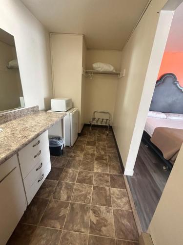 a small room with a bedroom and a bed at Capri Motel By Belvilla Walla Walla US 12 in Walla Walla