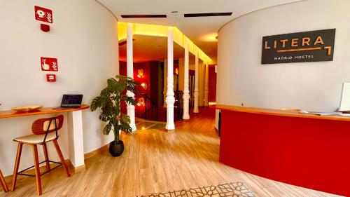a lobby with a desk and a sign for a library at Literal Hostel Madrid in Madrid