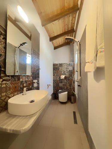 a bathroom with a white sink and a mirror at Rainbow Apartments in Skala Potamias