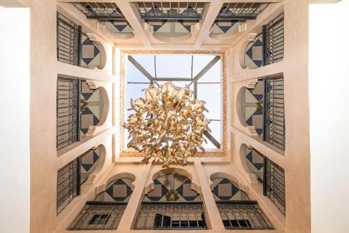 a chandelier hangs from the ceiling of a building at Villa riad raffinée privée à Marrakech in Marrakech