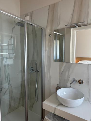 a bathroom with a sink and a glass shower at Il Giardinetto - Guest Room Policlinico in Messina
