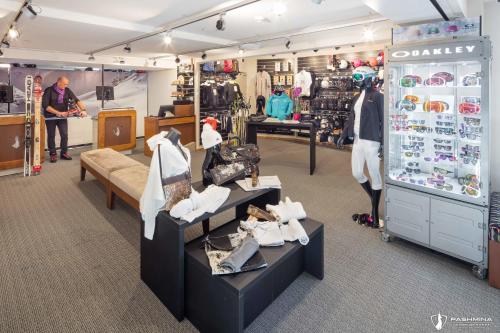 a clothing store with a man standing in the store at Hotel Pashmina Le Refuge in Val Thorens