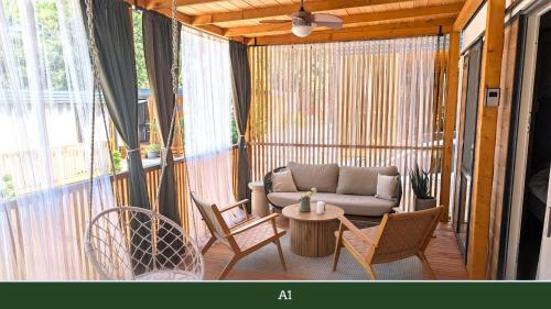 een woonkamer met een bank, stoelen en een tafel bij Mobile Homes Jaki in Biograd na Moru