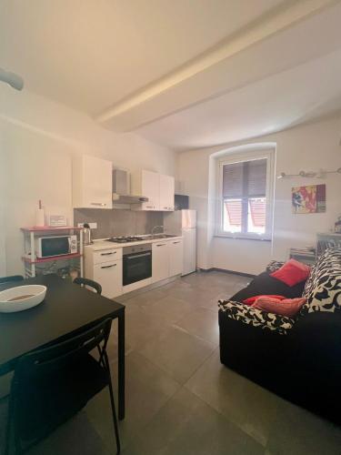 a kitchen and living room with a couch and a table at Numero5 in Rapallo