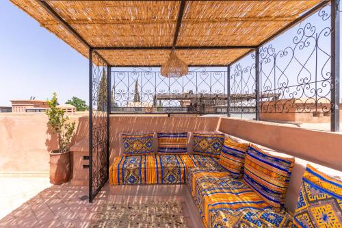 a bed on the back of a balcony at Villa riad raffinée privée à Marrakech in Marrakech