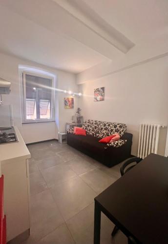 a living room with a black couch and a window at Numero5 in Rapallo