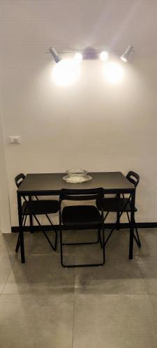 a black table with two chairs in a room at Numero5 in Rapallo