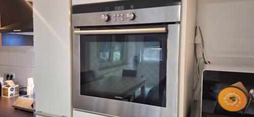 a kitchen with an oven with a table inside at Privat Appartement R D-2 in Bruchköbel