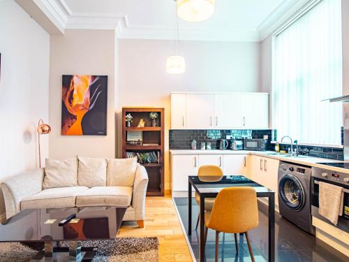a kitchen and living room with a couch and a table at Bessemer House in Sheffield