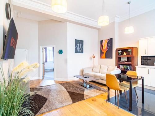 a living room with a couch and a table at Bessemer House in Sheffield
