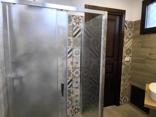 a shower with a glass door in a bathroom at Agriturismo Travaglianti Alloggio Etna in Ragalna