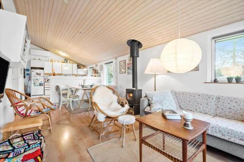 a living room with a couch and a table at R963-Rodvig-Skovstumperne-3 in Rødvig