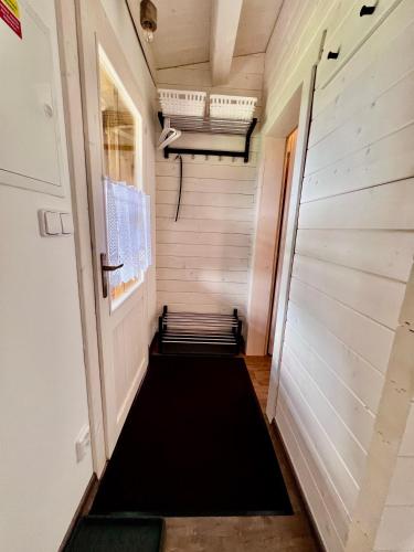 a hallway of a tiny house with a black rug at Log cabins at Iron Rose in Czech Canada in Nová Bystřice
