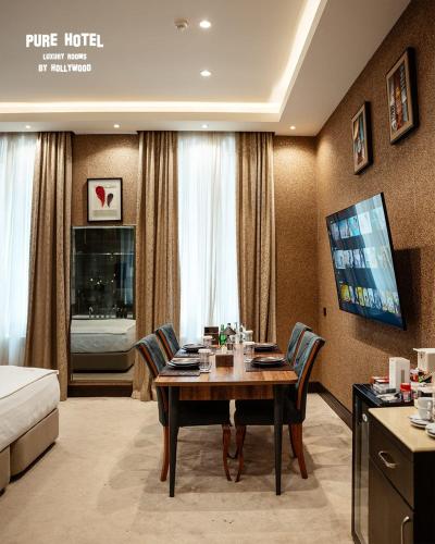 a dining room with a table in a hotel room at Pure Boutique Hotel in Baku