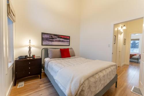 a bedroom with a bed and a dresser and a window at Alpine Village Condo by Canadian Rockies Vacation Rentals in Canmore