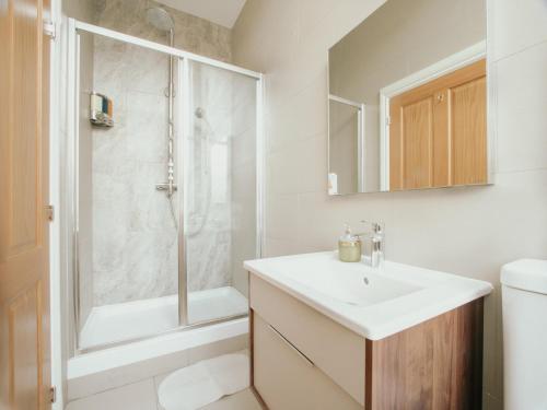 a white bathroom with a sink and a shower at Bessemer House in Sheffield