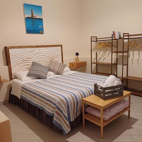 a bedroom with a large bed and a shelf at Civico18 in Fiumicino