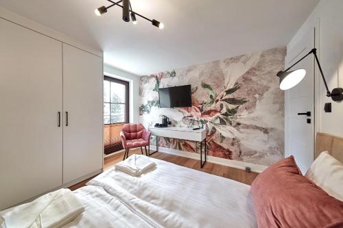 a bedroom with a bed and a desk at Leśny Dworek - Pokoje & Apartamenty in Białka Tatrzanska