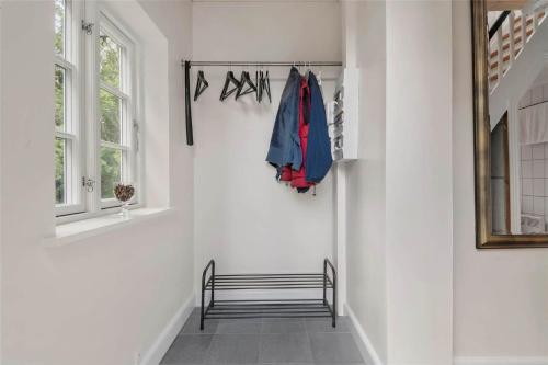 a hallway with white walls and a stairway with a bench at 3039-Stege-Stejlepladsen-1-3 in Stege
