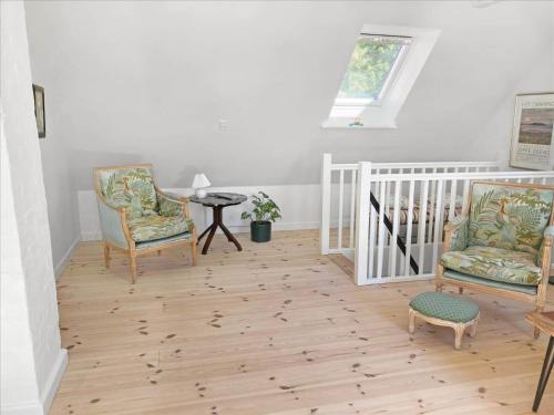 a living room with two chairs and a table at 3039-Stege-Stejlepladsen-1-3 in Stege