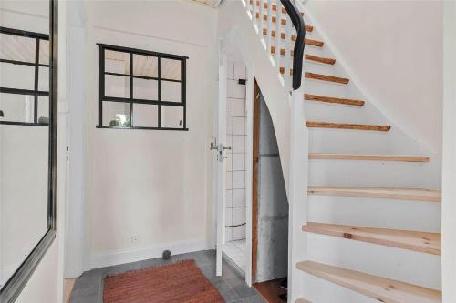 a staircase in a home with white walls and a window at 3039-Stege-Stejlepladsen-1-3 in Stege