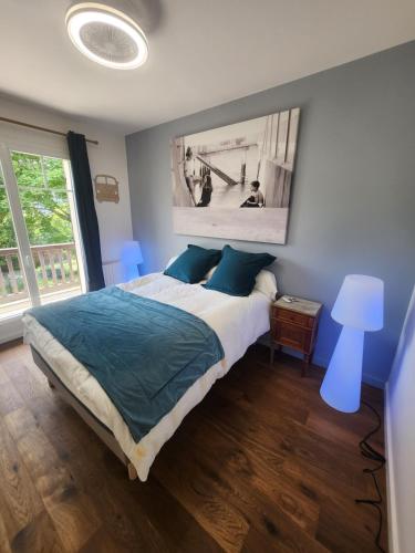 a bedroom with a bed and a large window at Villa Piscine près Golf Arcachon in La Teste-de-Buch