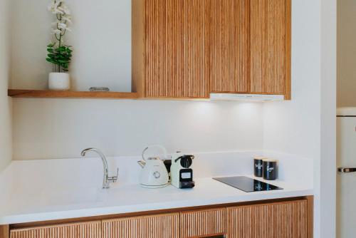 a kitchen counter with a sink and a kettle at Volaka Luxury Suites in Kos Town