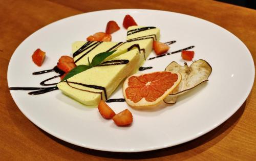 a white plate with a dessert on a table at Hotel Rotwand in Laives
