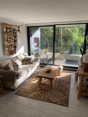 a living room with a couch and a table at Acogedor departamento de lujo in Pucón