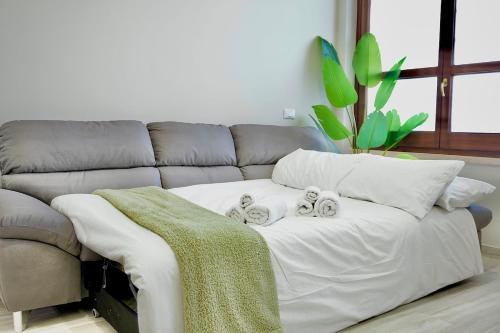 a living room with a couch with two pillows at Space and comfort a stone's throw from Milan and Linate in Pioltello