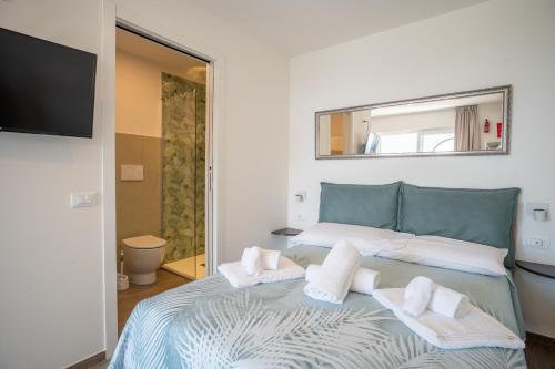 a bedroom with a bed with towels on it at Camping Village Panoramico Fiesole in Fiesole