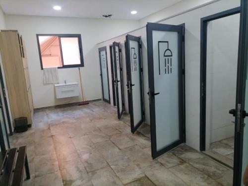 a row of doors in a room with a tile floor at jnane ali akioud Gueliz in Marrakech