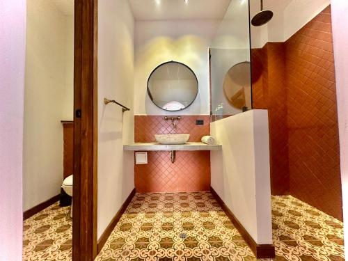 a bathroom with a sink and a mirror at Masaya Cartagena in Cartagena de Indias