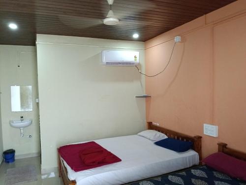 a small room with a bed and a sink at Gokarna Beach Near Stay in Gokarna