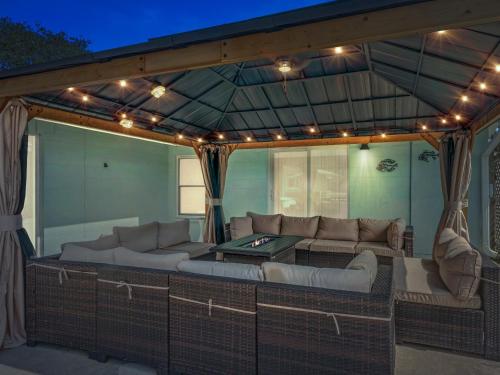 a covered patio with a couch and a table at The Sea Glass House in Rockport