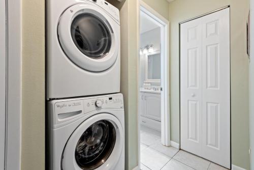 a white washer and dryer in a laundry room at Siren’s Song, Minutes to IMG & Anna Maria Island in Bradenton