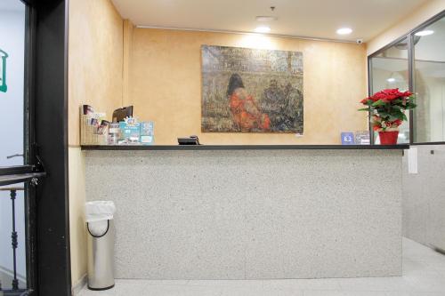 a counter in a store with a painting on the wall at El Jardi in Barcelona